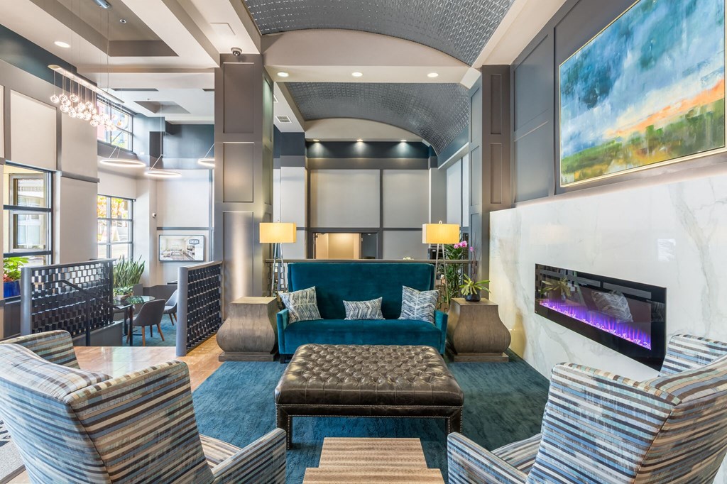 a living room with a blue couch and a fireplace