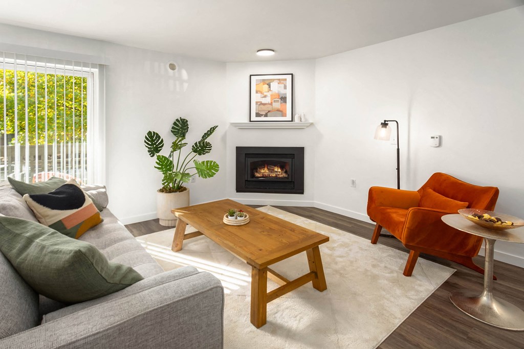 a living room with a couch and a table and a fireplace