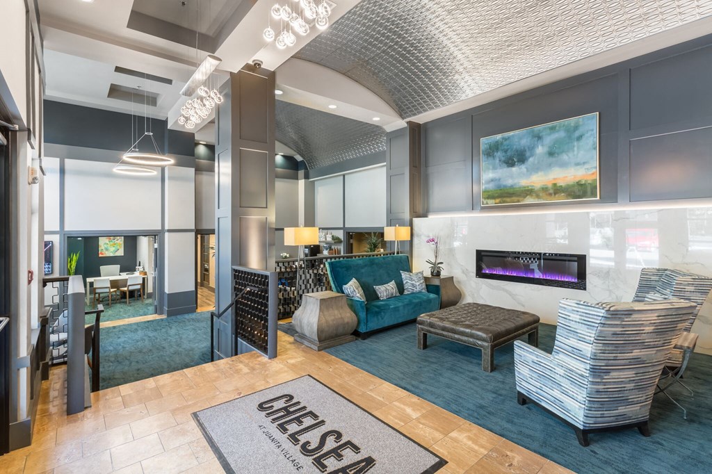 a lobby with a living room and a fireplace