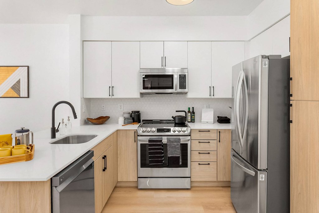 a kitchen with stainless steel appliances and white cabinets