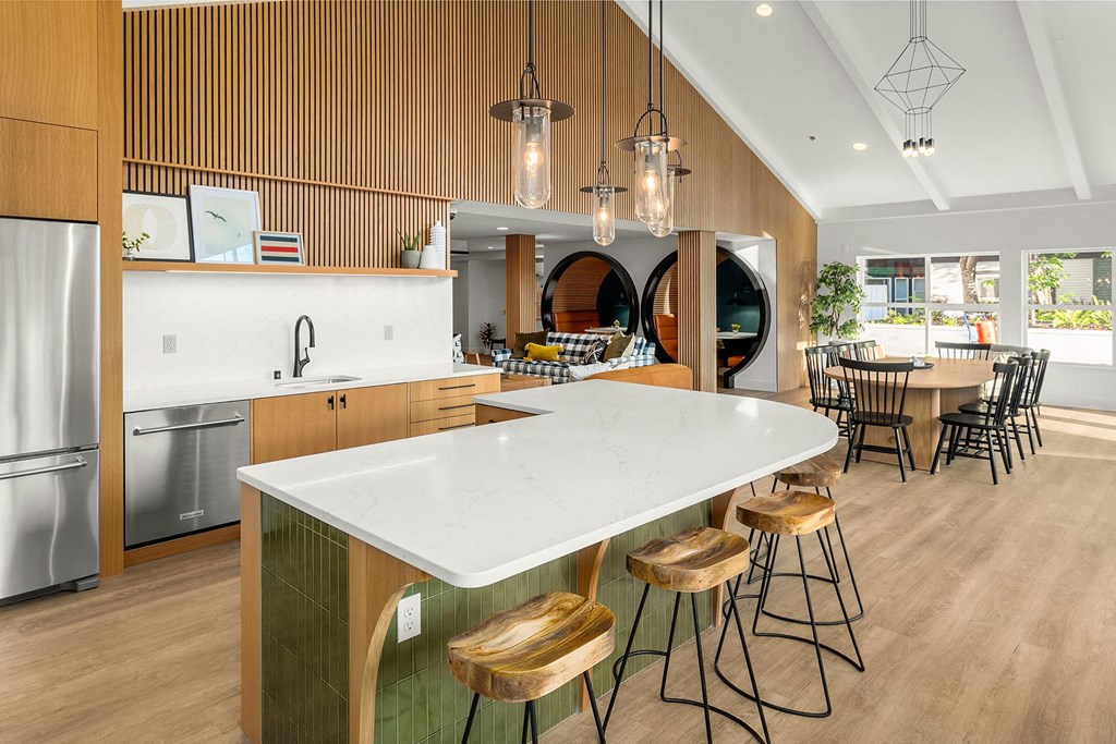 a kitchen with a large island and a dining table