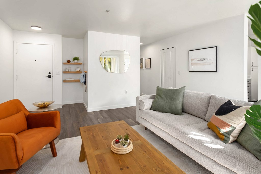a living room with a gray couch and a wooden coffee table