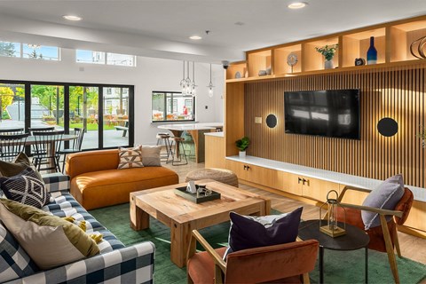 a living room with couches and a table and a television