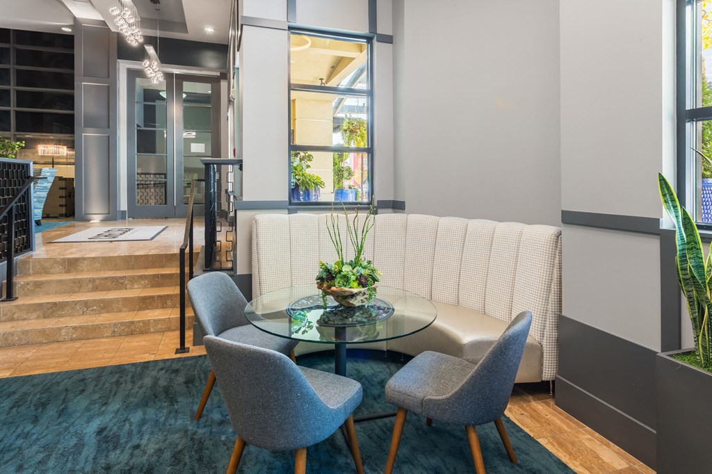 a living room with a table and chairs
