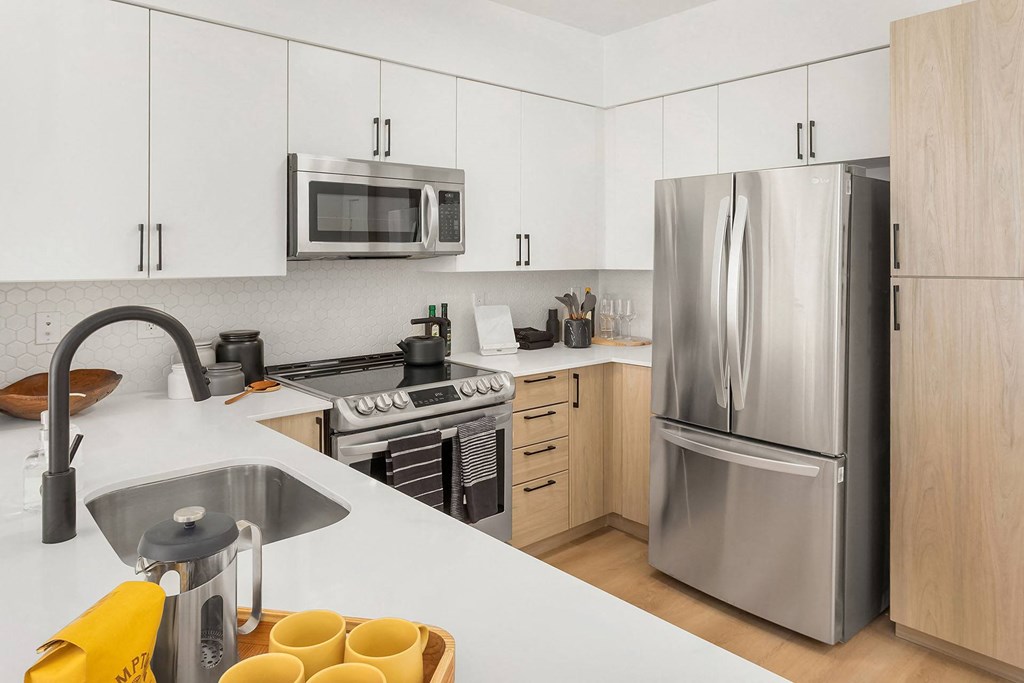 a kitchen with stainless steel appliances and white cabinets