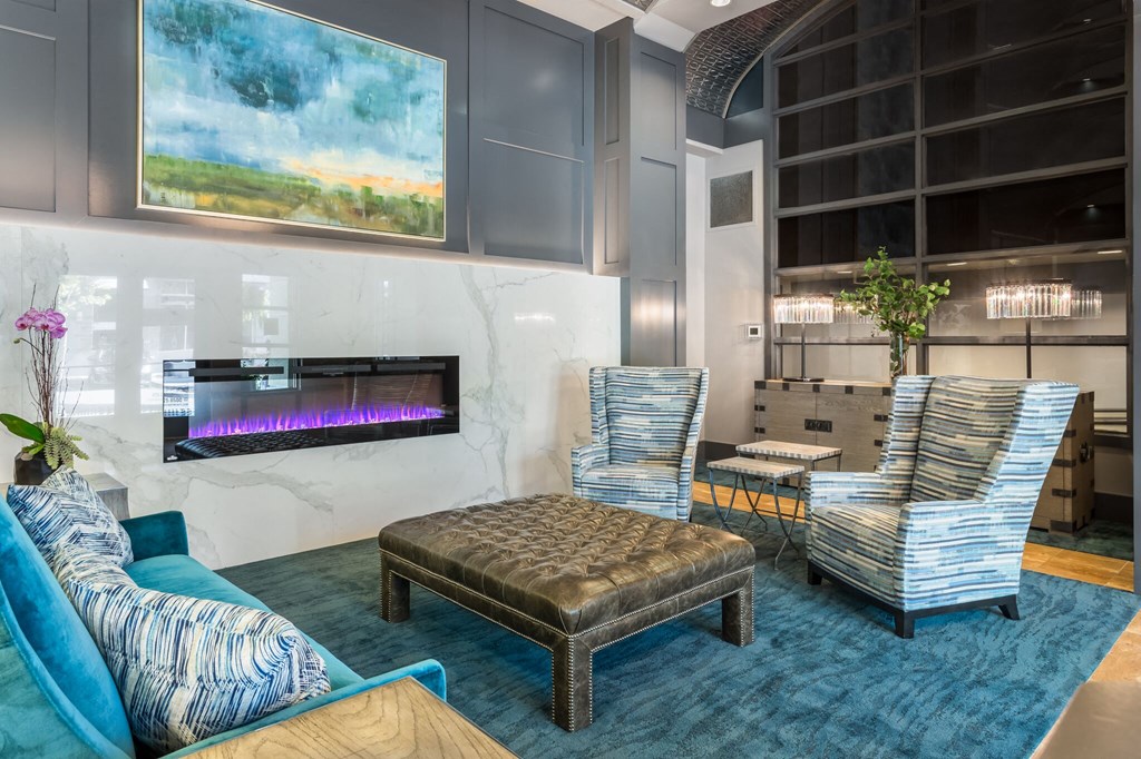 a living room with couches and chairs and a fireplace