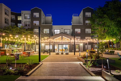 an exterior view of an apartment complex at night