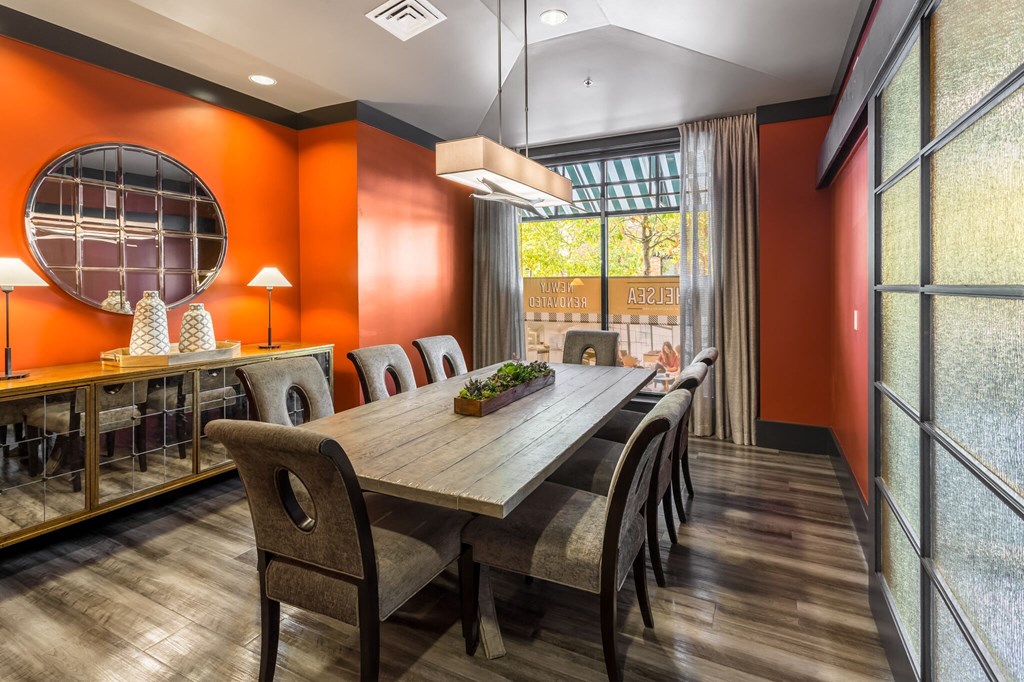 a dining room with a long wooden table and chairs