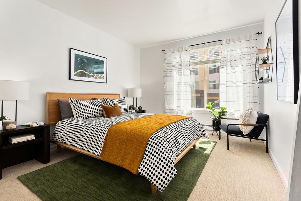 a bedroom with a bed and a large window