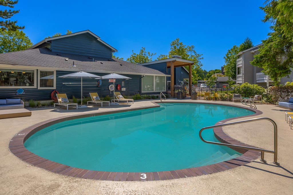 our resort style swimming pool is in front of our building and next to a house
