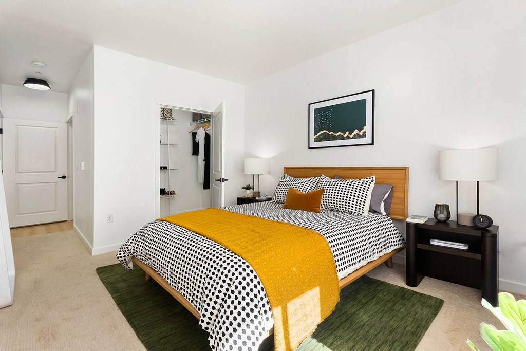 a bedroom with a bed and a yellow blanket