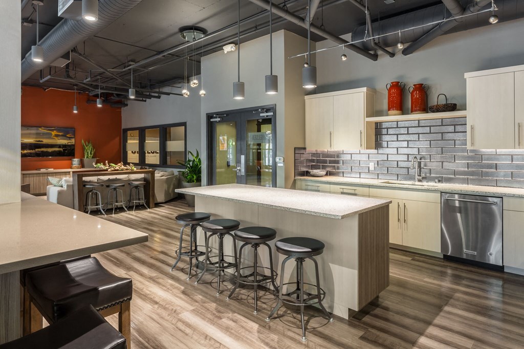 a kitchen with a large island and stools