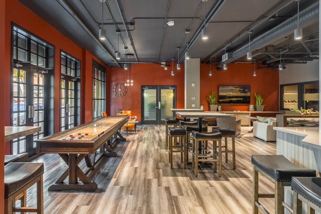 a game room with a pool table and tables