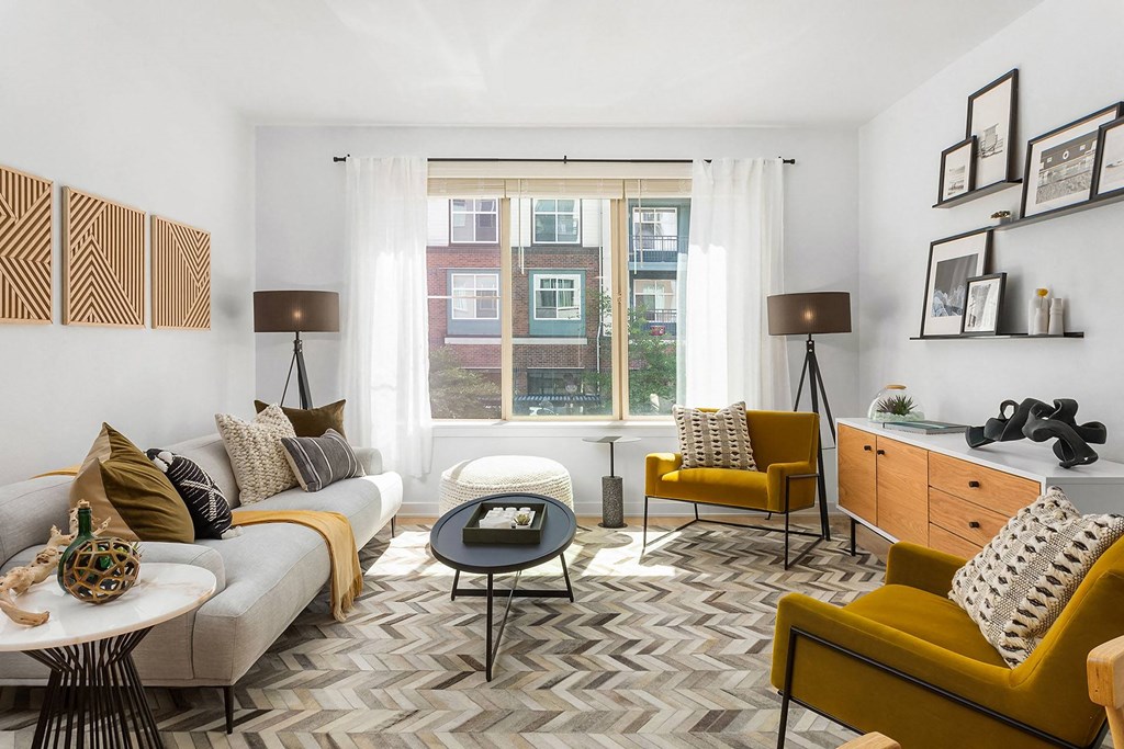 a living room with yellow furniture and a window