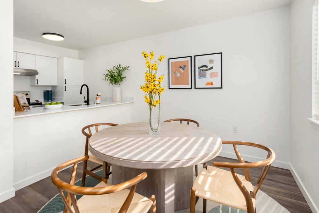 a dining room with a table and chairs and a kitchen