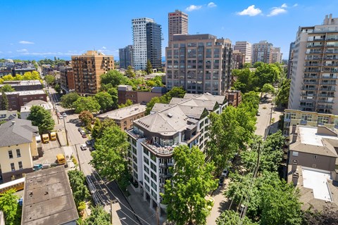 an aerial view of a city with tall buildings and trees