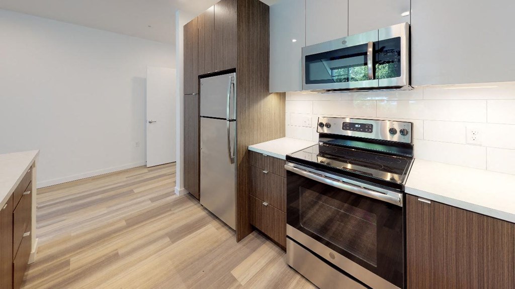 a kitchen with a stove and a refrigerator