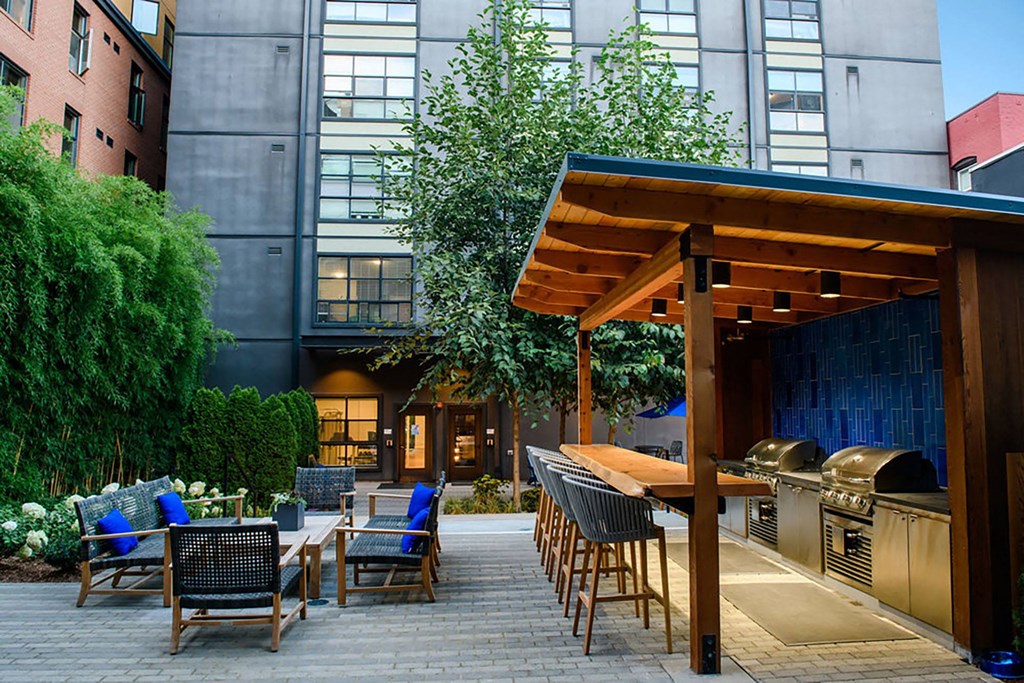 a patio with tables and chairs and a bar