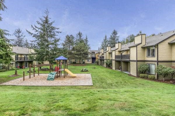 a yard with a playground and some houses