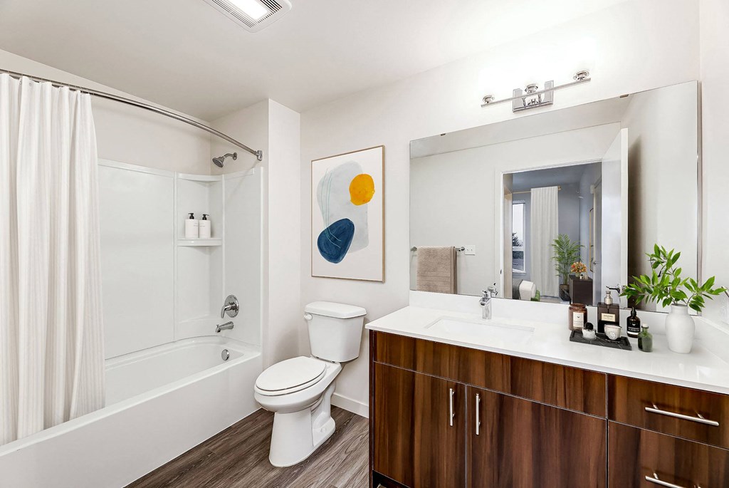 a bathroom with a toilet sink and a shower