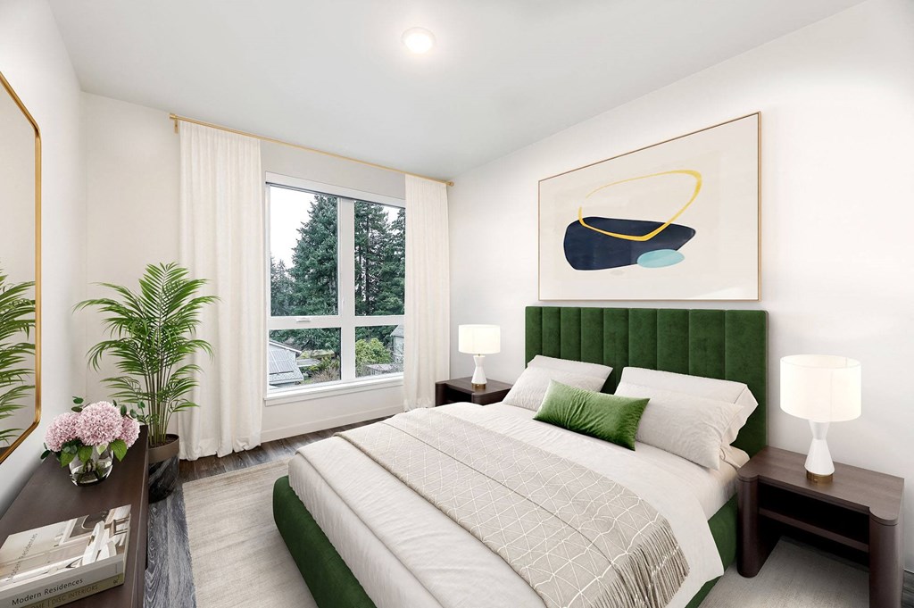 a bedroom with a bed and a large window