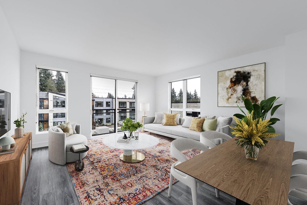a living room with white couches and a wooden table