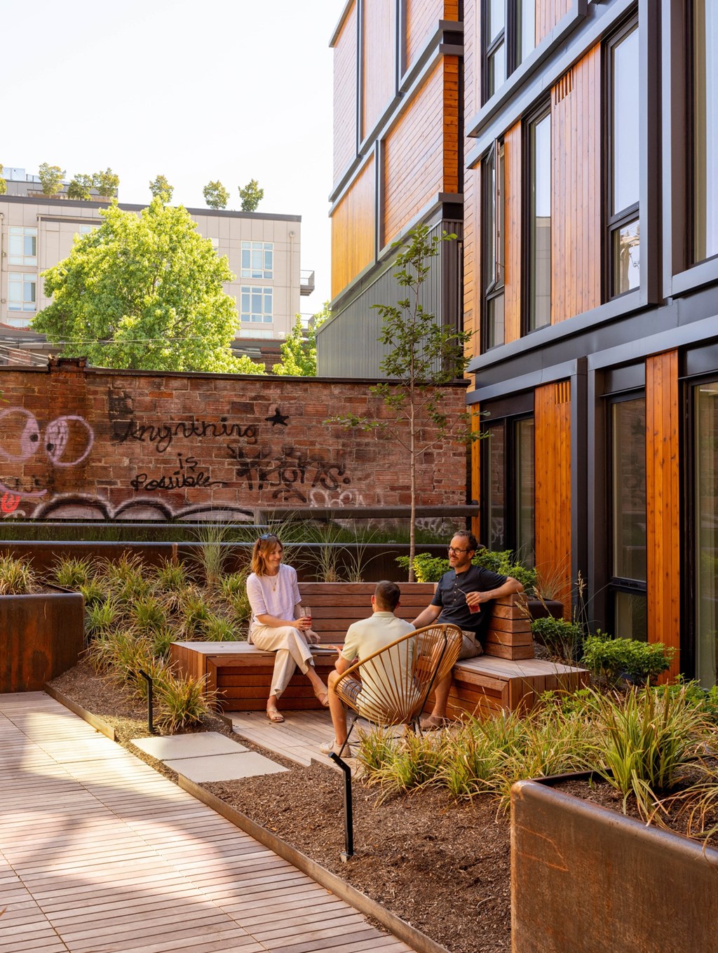 people sitting on benches in a courtyard outside of a building