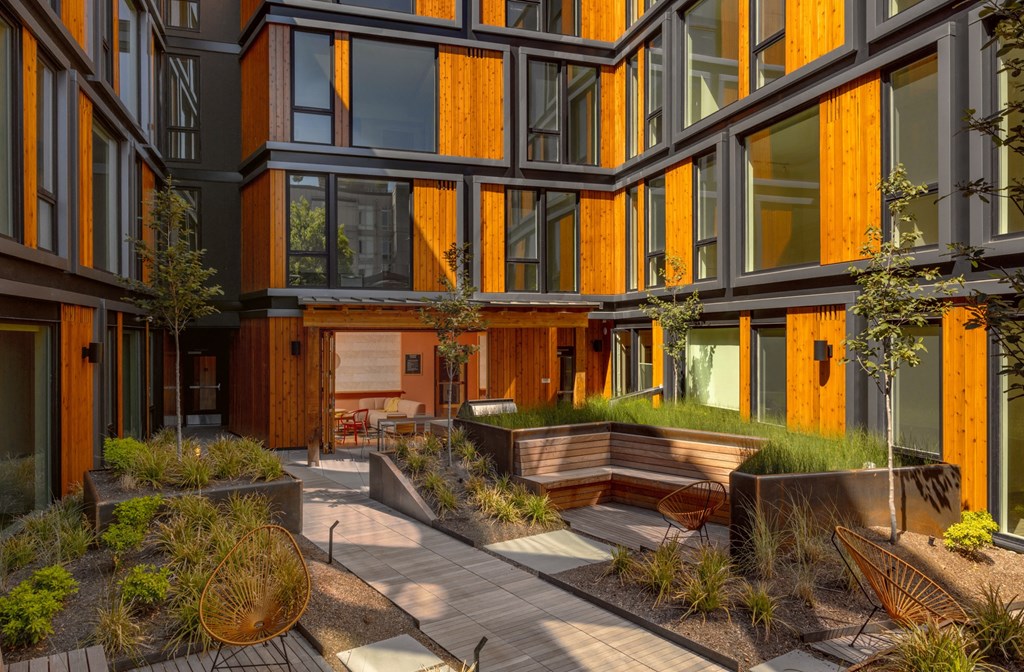 the courtyard of a building with trees and plants