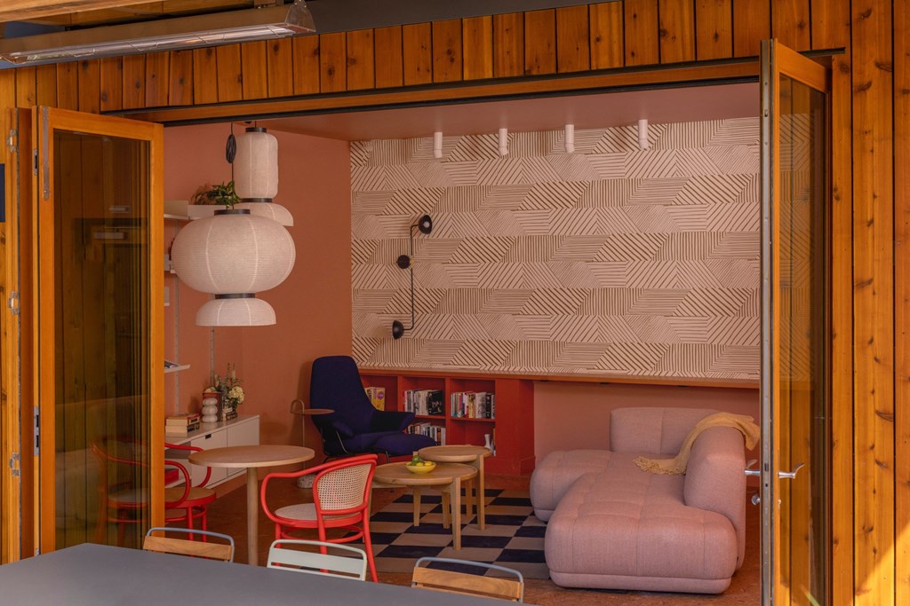 a living room with a couch and chairs and a table