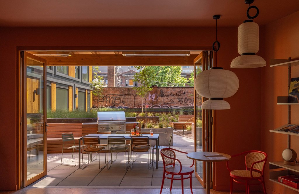 a restaurant patio with tables and chairs and a wall with graffiti