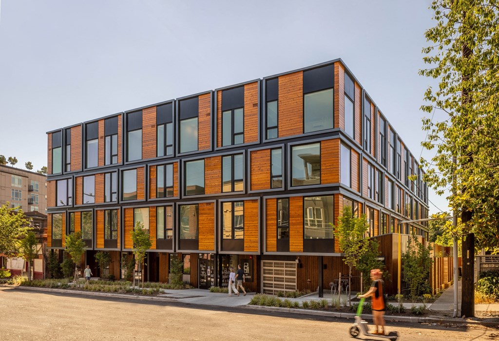 a large building with many windows and a child on a scooter