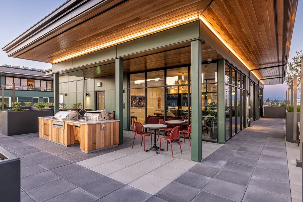 a patio with a hot tub and a table and chairs