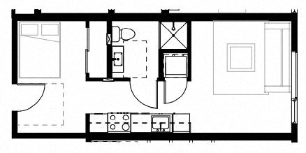 a room with a bed a sink and a mirror