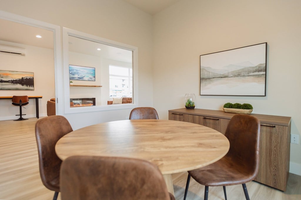 A dining room with a wooden table and chairs.