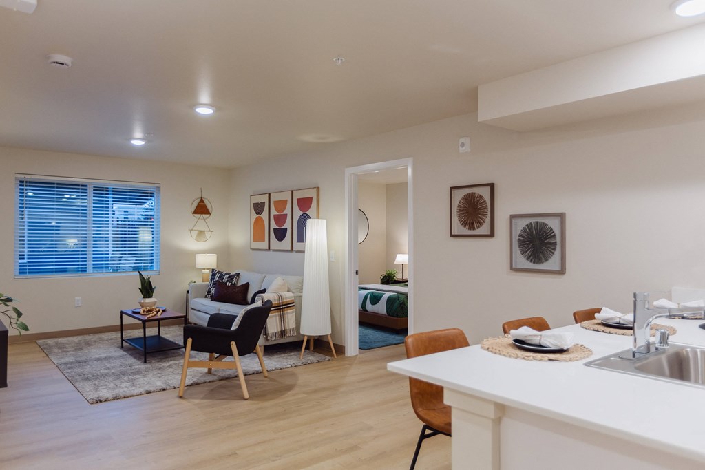 A modern kitchen with a dining table and chairs.