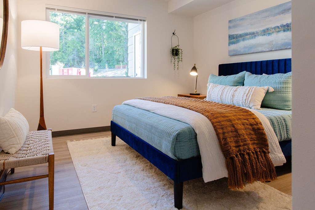 a bedroom with a bed and a window