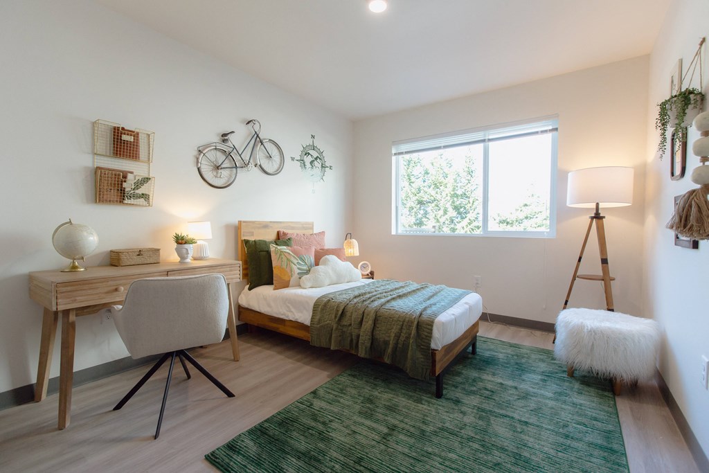 a bedroom with a bed and a desk