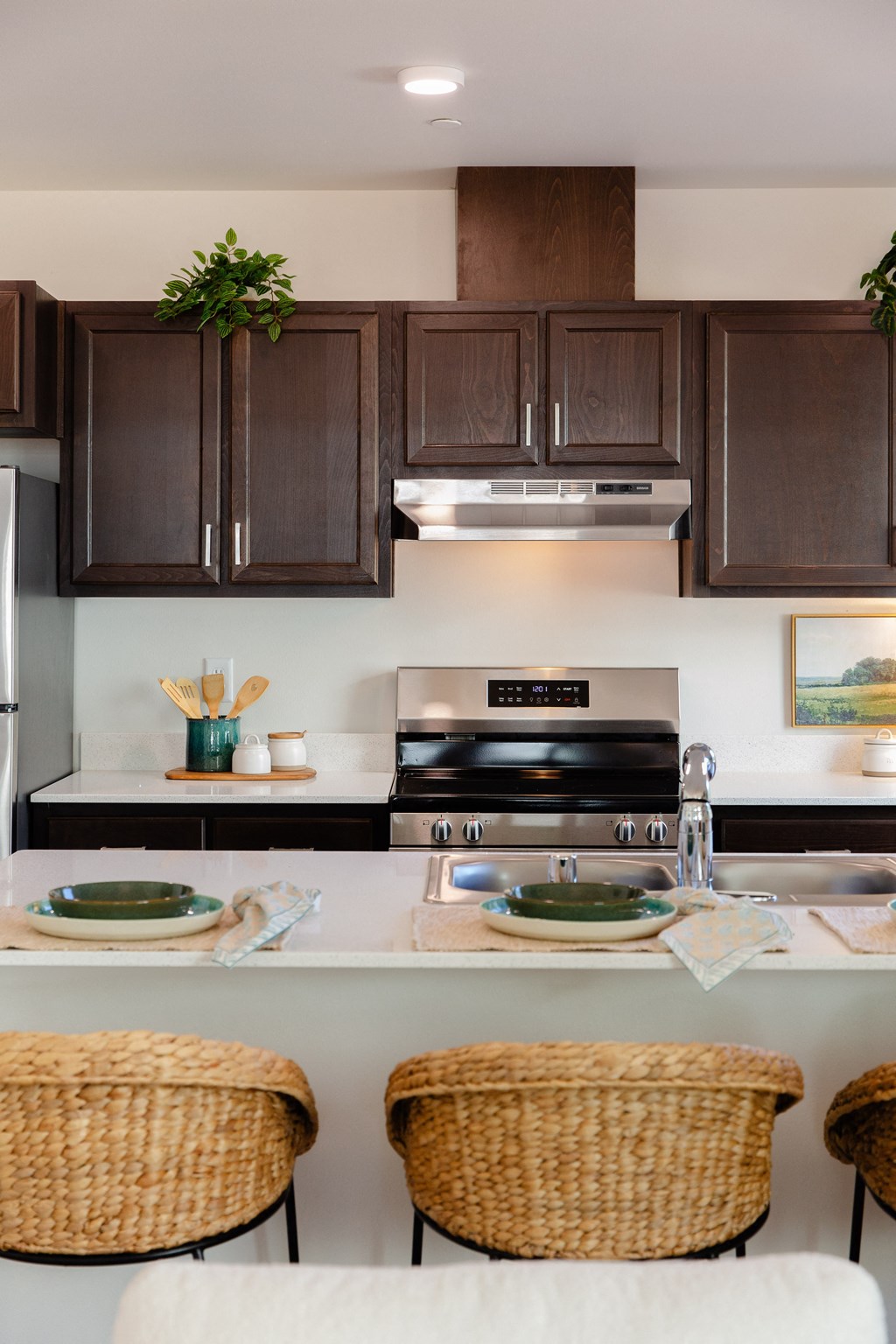 a kitchen with brown cabinets and a white counter top and a sink