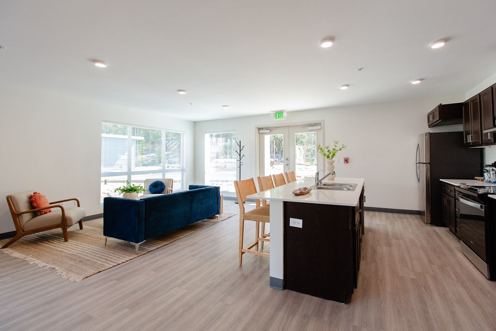a living room with a kitchen and a dining room