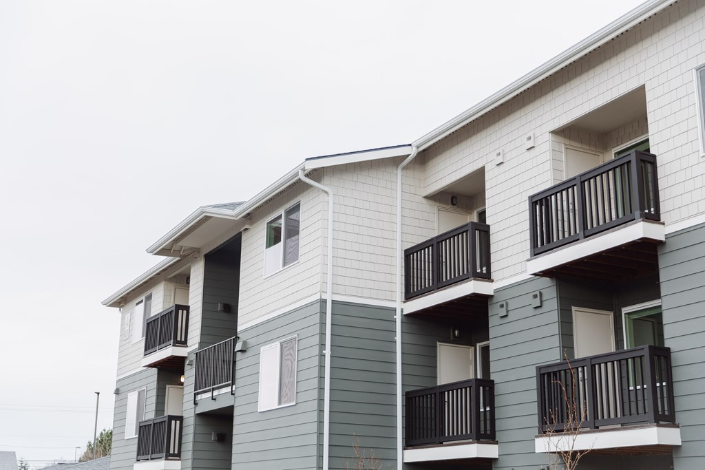 Apartment building with balconies and doors.