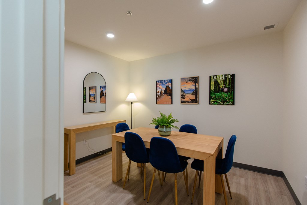 a dining room with a wooden table and blue chairs