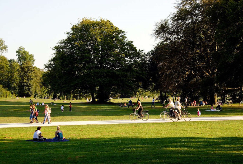 people walking and biking in a park