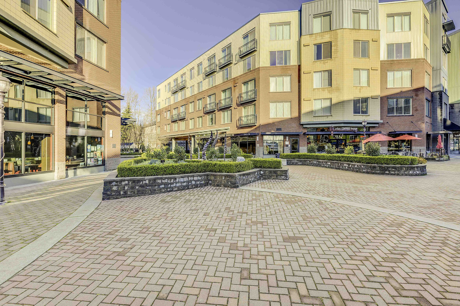 a building with a brick courtyard in front of it