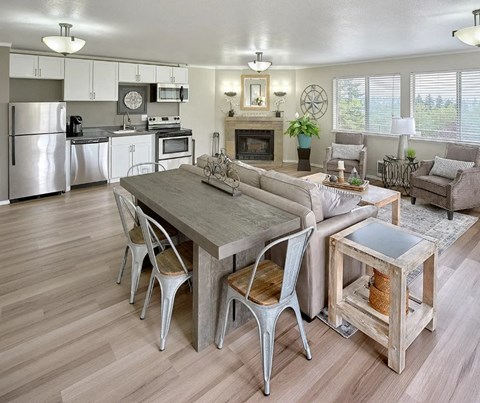 A modern kitchen with a dining table and chairs.