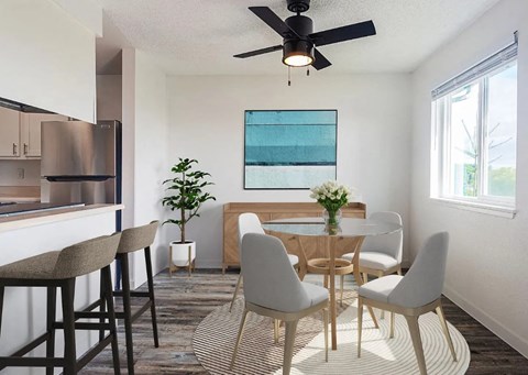 A dining room with a table set for four.