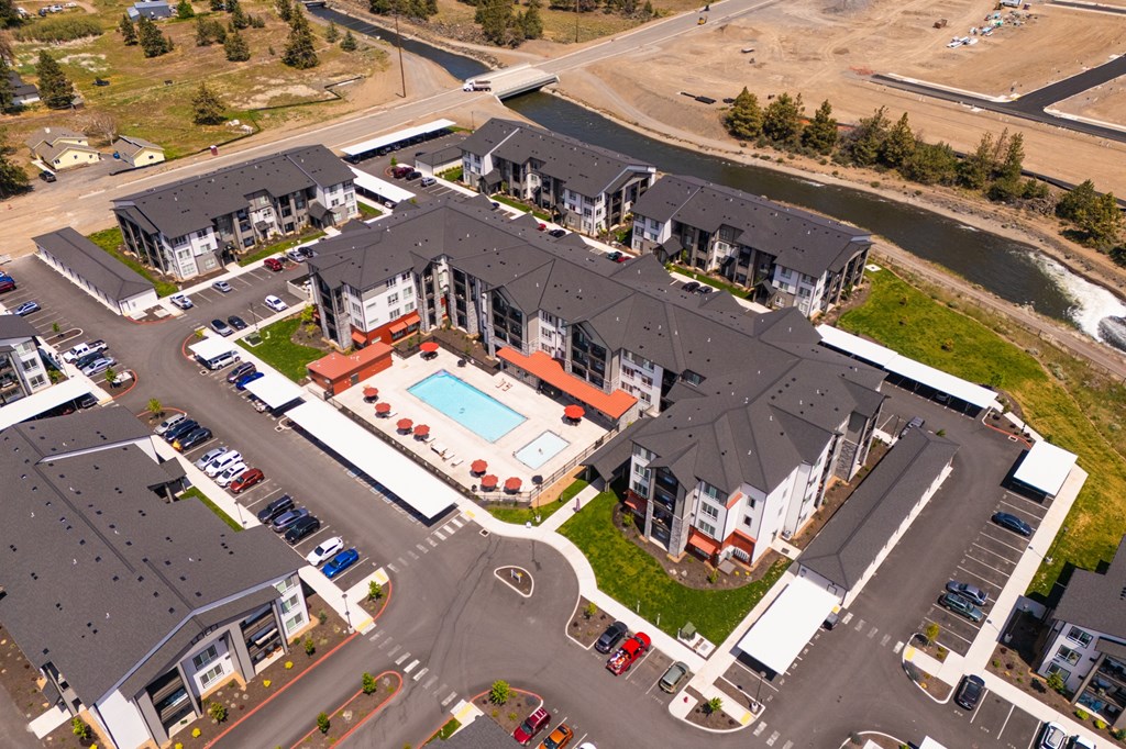 A bird's eye view of a residential complex with a swimming pool.