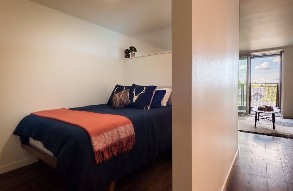 a bedroom with a bed and a sliding glass door
