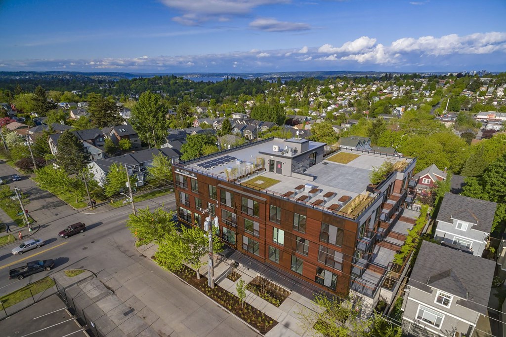 an aerial view of a building in a city with trees
