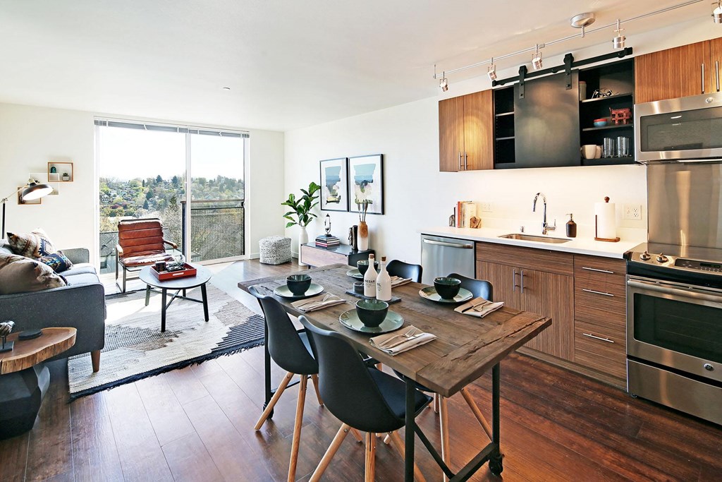 a kitchen and living room with a table and chairs