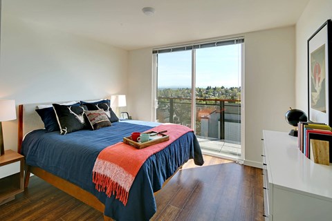 a bedroom with a bed and a sliding glass door
